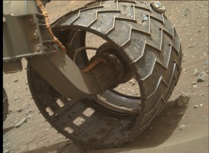 Rock embedded into wheel of NASA's Mars rover Curiosity. The robot acquired this image using its Mars Hand Lens Imager (MAHLI), located on the turret at the end of the rover's robotic arm, on April 30, 2015, Sol 971. Credit: NASA/JPL-Caltech/MSSS 