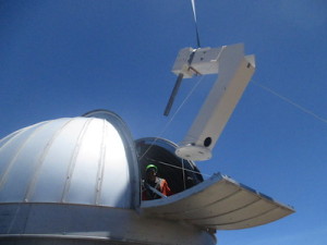 The mount for the Haleakala observatory is lifted into the dome. Credit: ATLAS team