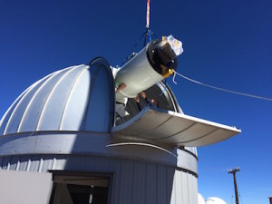 ATLAS#1 telescope gently lowered into Haleakala observatory. Credit: ATLAS team