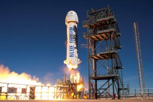 Blue Origin's New Shepard booster takes flight. Credit: Blue Origin